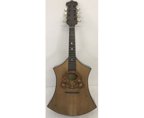 A vintage German unusual shaped mandolin with mother of pearl detailed inlay. Needs new strings. 