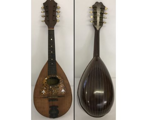 A vintage cased Stridente Italien 8 stringed Mandolin. With tortoiseshell and mother of pearl detail. Original label still in