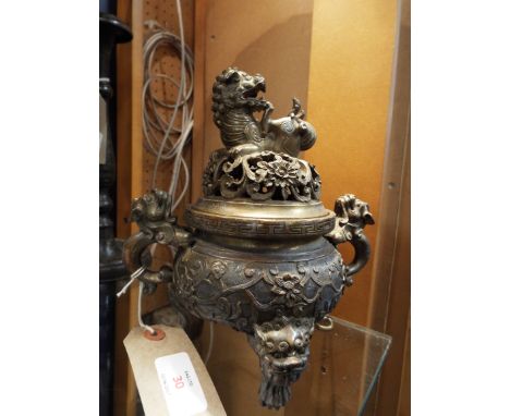 A Chinese brass Koro, the floral pierced lid surmounted with dragon above a similar decorated body with twin dragon handles a
