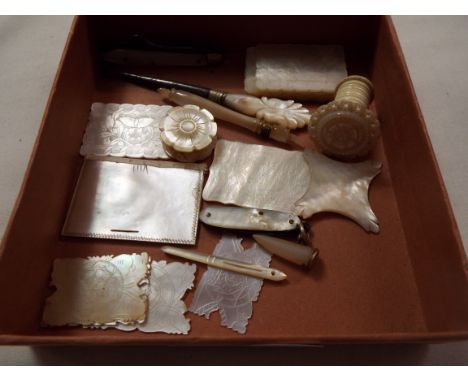 A selection of mother of pearl needlework tools to include silk winders, needle case, hook, penknives etc