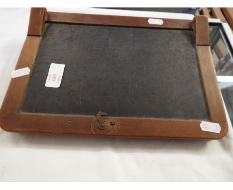 A vintage child's wooden school desktop chalkboard box with lift-up lid and interior containing educational aids, ruler, chal