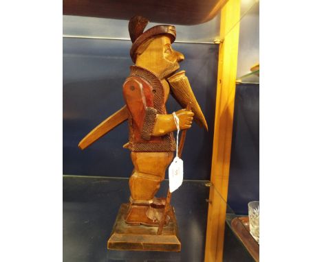 A circa 1900's carved wooden nutcracker figure of a woodsman in working order     split to base 14" high