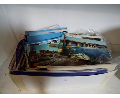 A box of assorted postcards to include scenic, architectural etc