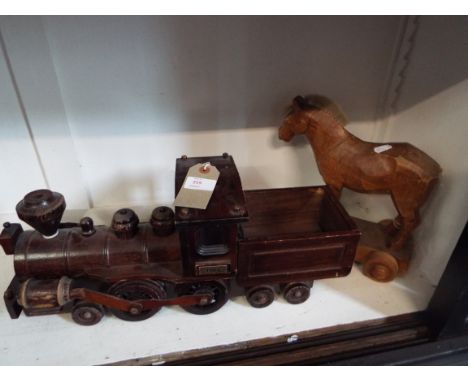 A wooden model of a tank engine and tender together with a wooden pull along horse