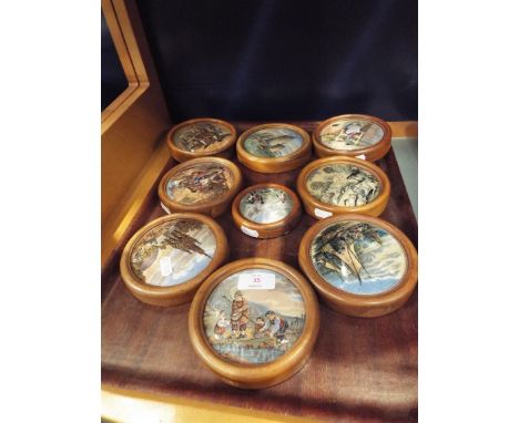 A selection of nine Prattware pot lids depicting various scenes to include architectural, boating scenes etc 