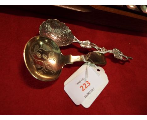 A silver-plated caddy spoon and a silver plated spoon with vine decoration marked '90'