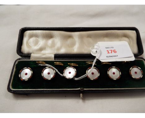 A cased set of early 20thC mother of pearl buttons with central red stones