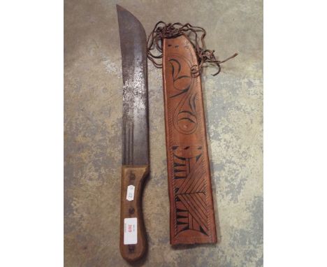 A machete in leather scabbard