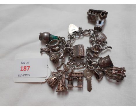 A sterling silver charm bracelet with numerous charms