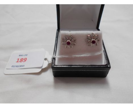 A pair of white gold earrings inset with ruby and diamonds