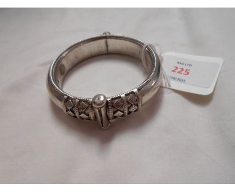 A late 20th C silver hinged bangle with applied lozenge and gadrooned decoration having pin clasp