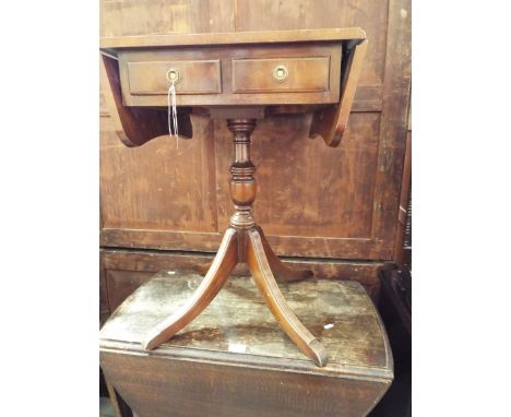 A Georgian style mahogany drop-leaf side table fitted with two frieze drawers with brass drop ring handles, raised on column 