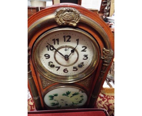 A Wari Clock Company brass mounted mantel clock with white enamel dial and Roman numerals with interior label inscribed Haug 