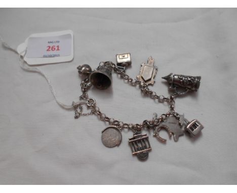 A sterling silver charm bracelet with numerous charms