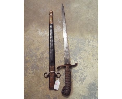 A Victorian Naval Officer's short sword with 45.5cm etched blade and lion's head pommel and wire bound shagreen grip in a gil