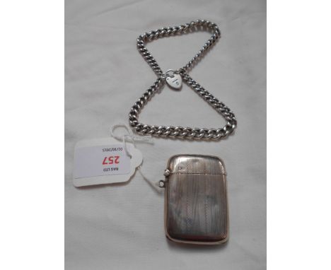 A Chester 1919 silver Vesta case with engine turned decoration and a silver link chain with padlock