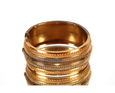 A Victorian yellow metal snap bangle with filigree work decoration inscribed to the interior, Ada Louisa Whiffin presented by