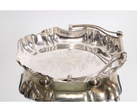 An Edwardian silver swing handled fruit basket with shaped border and leaf decoration by Walker &amp; Hall, Sheffield 1908. 1