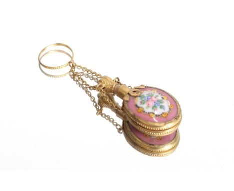 A small pink porcelain scent bottle, having gilded mount and stopper hung with a fine link chain and ring, 6cm long