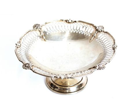 A silver comport, having pierced and shell decorated shaped border raised on a circular spread foot, Birmingham 1923, 21cm di
