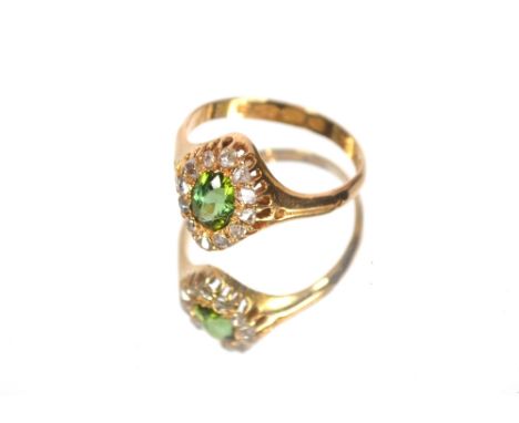 An 18ct gold ring set with approximate 1/2 carat emerald, surround by diamonds.  Approximate total weight 3.5gms, ring size Q