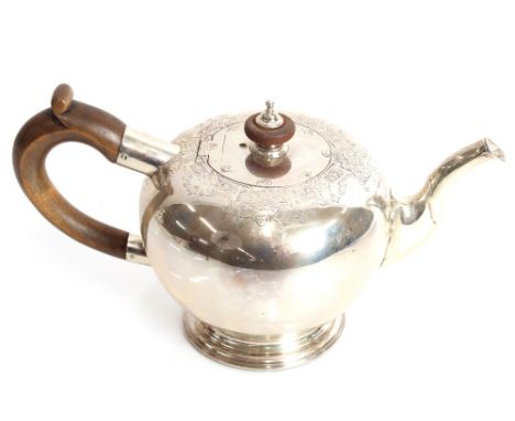 A George V silver bullet shaped bachelors teapot, foliate engraved decoration, wooden handle and lift, London 1924, makers ma