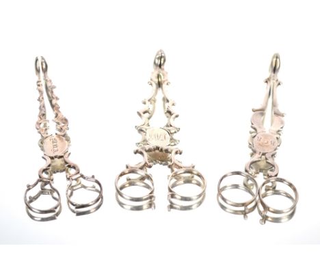 A pair of George III silver scissor action sugar nips by William Plummer 1753.  Another pair by David Willaume, London 1799 a