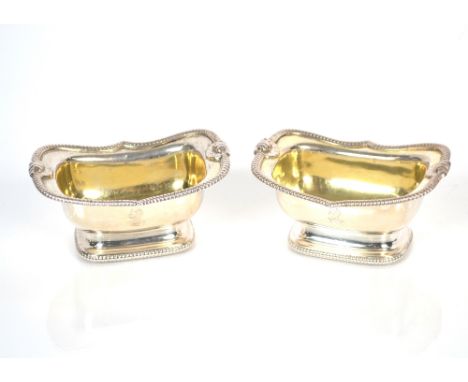 A pair of George III silver salts, by J.T. Young &amp; Co. gilded interiors, beaded and shell decoration to the shaped border