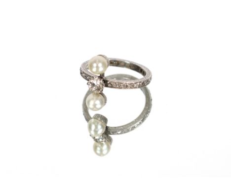 A white metal eternity ring set central diamond flanked by two pearls and diamond set band, approx. 4gms total weight, ring s