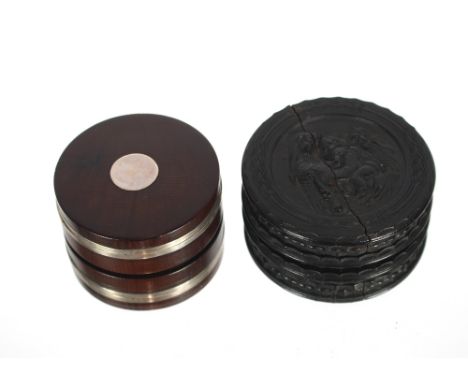 A circular partridge wood and white metal banded snuff box, 7cm diameter and a circular dark hardwood snuff box, the lid deco