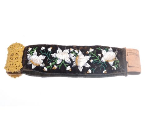 A yellow metal bangle set with red stones; a bead work bangle with yellow metal clasp; a seed pearl brooch; a seed pearl neck