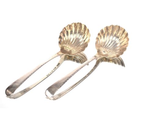 A pair of George III silver sauce ladles with feather edged borders and fluted bowls.  Maker Thomas Ellis, London 1770
