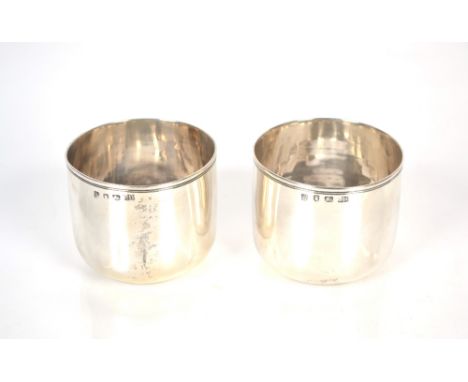 A pair of George III silver beakers, of plain form, maker Charles Hougham, London 1765, 216gms,&nbsp; 7.8cm dia. x 6cm high