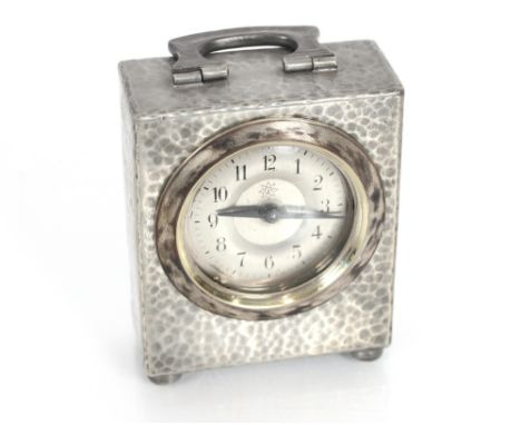 A Liberty &amp; Co pewter cased carriage clock, spot hammered decoration and angular folding handle, 20cm high