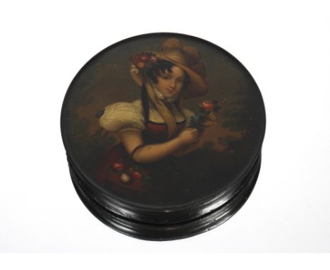 A 19th century circular papier maché box, the lid decorated with a scene of a young lady holding a flower, faint inscription 