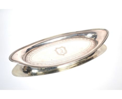 A small George III oval silver serving dish, having reeded border, engraved decoration and central cartouche with family cres