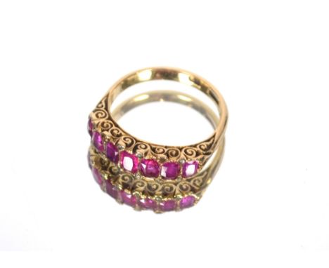 An 18ct gold ring set seven coloured stones, approximately 4.2gms total weight.  Ring size O