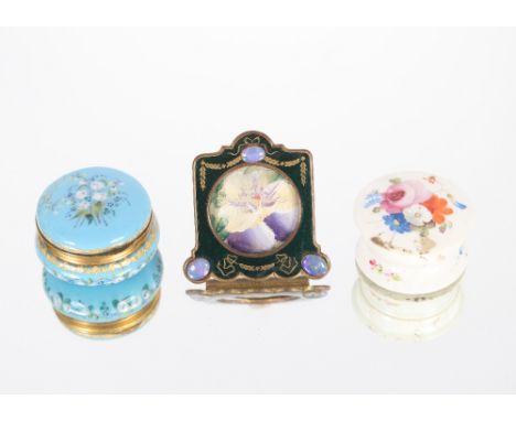 A small turquoise enamelled hinged patch box with gilded interior; an enamelled miniature easel frame with moonstone style de
