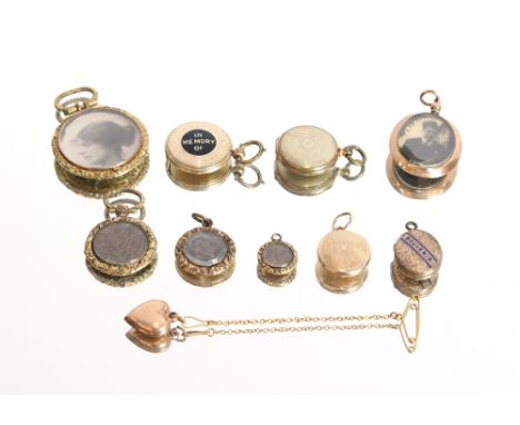 A 9ct gold mounted, double sided photo locket; a yellow metal and black enamel memorial locket, inscribed in memory of; a yel