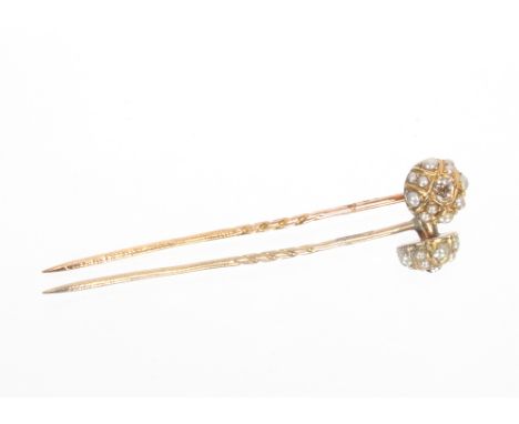 A yellow metal stick pin set with diamonds, surrounded by seed pearls, diamond approximately 0.15 carat, approximately 1.8gms