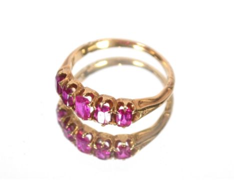 A yellow metal ring set five coloured stones, approximately 3gms total weight.  Ring size M.
