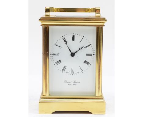 An English brass carriage clock, circa 1980s, retailed by David Peterson London, the enamelled dial with Roman numerals, hous