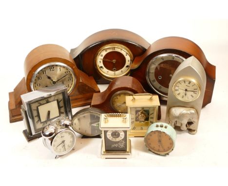 A collection of mid 20th century and later mantel clocks, having manual wind and quartz movements, in two boxes. (2)