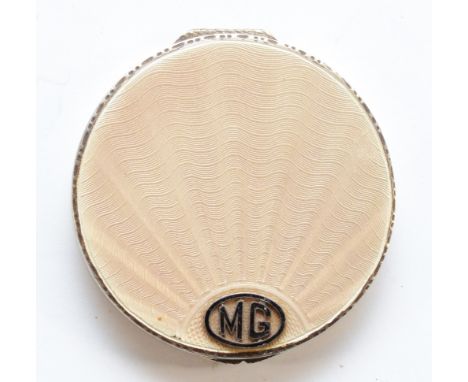 An Art Deco silver and cream guilloche enamel compact, Birmingham 1931, with applied MG monogram, original mirror and twist p