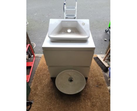 An unused bathroom vanity unit, together with two ceramic vanity basins