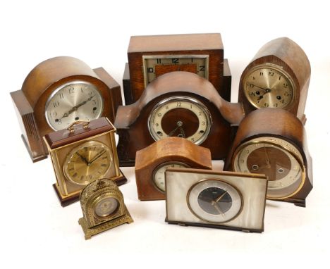 A collection of mid 20th century and later mantel clocks, together with a quantity of wall barometers,having manual wind and 