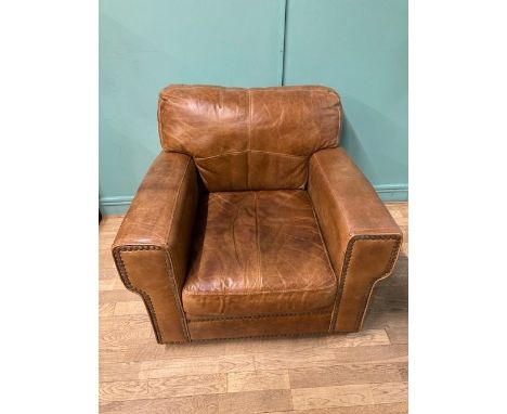 A modern light tan nubuck leather armchair with matching footstool, W81, D93, H84cm. (2)