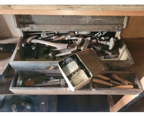 A wooden tool box containing an assortment of carpentry tools, also a tin containing furniture hinges, locks, handles, and es