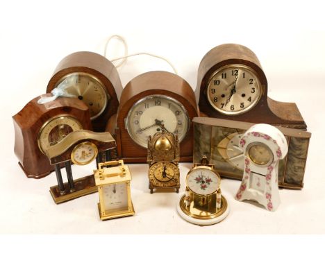 A collection of mid 20th century and later mantel clocks, having manual wind and quartz movements, in two boxes. (2)