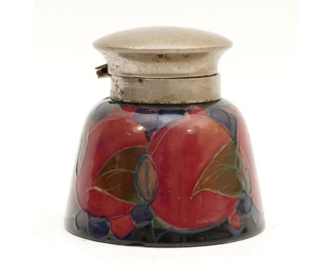 A Moorcroft inkwell, in the pattern, 'Pomegranate', with a pewter rim, manufactured between 1928 and 1949, complete with gree
